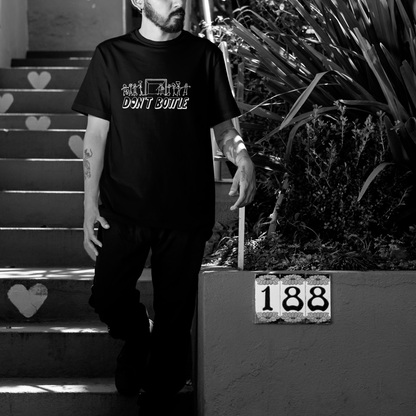 Close-up of Don’t Bottle black unisex cotton t-shirt — graphic detail and soft texture.