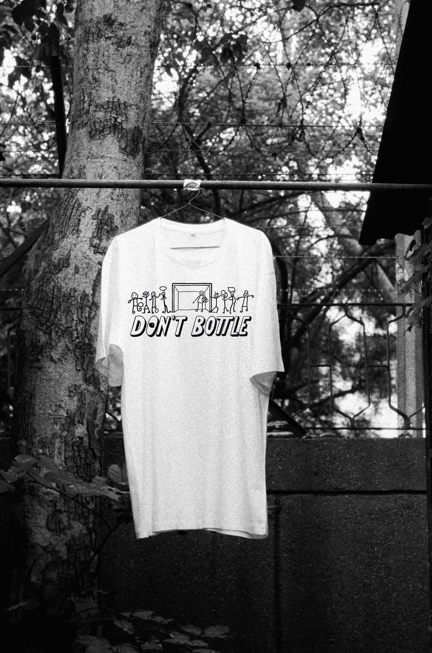 Front view of Don’t Bottle white oversized unisex t-shirt by Blaknwhite — soft cotton streetwear design.