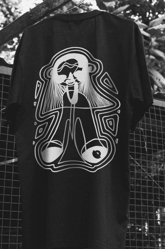 Oversized black T-shirt with a round neck and short sleeves, featuring a white graphic design of a stylized character by Blaknwhite
