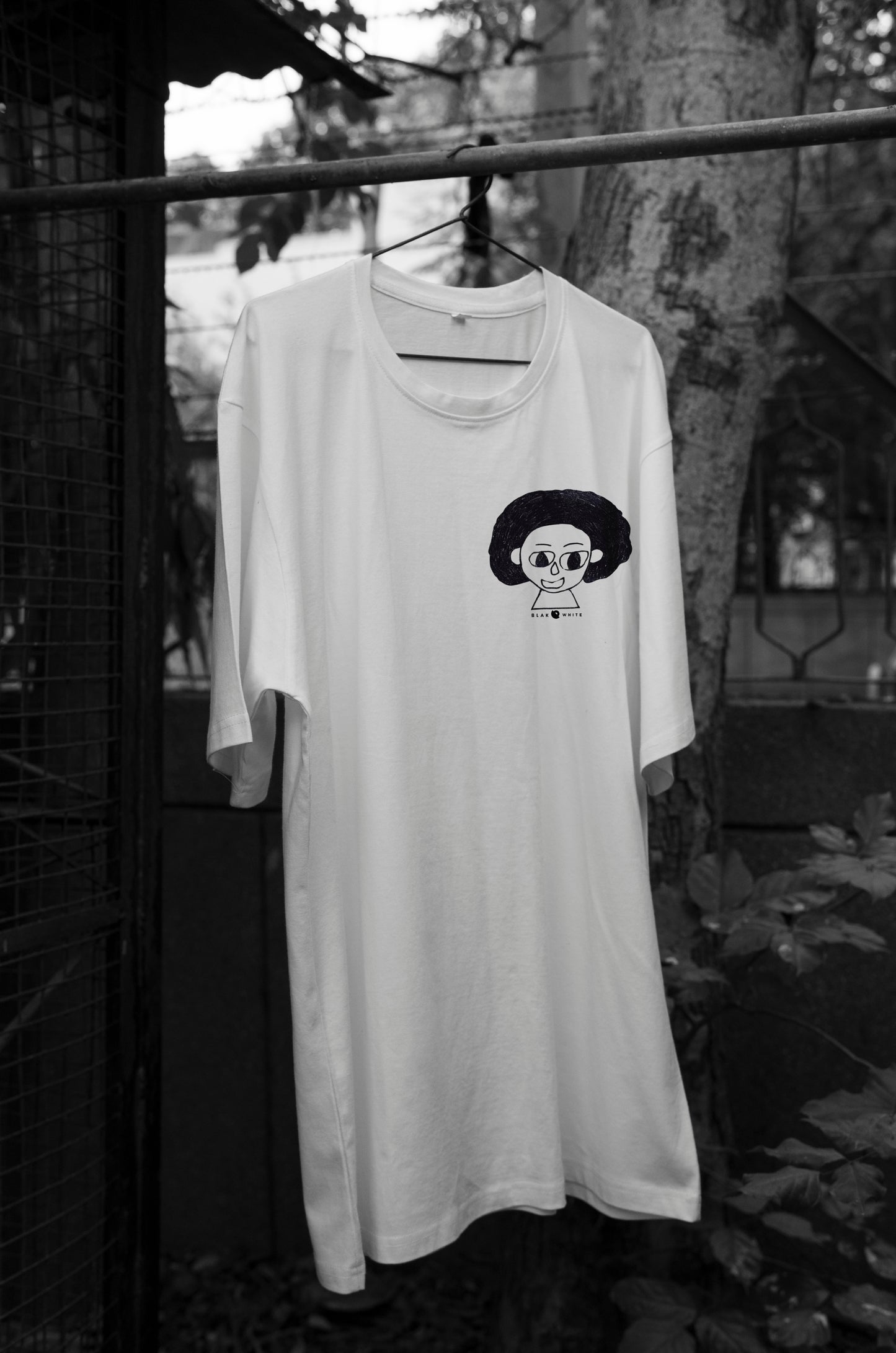 Front view of The Artist white oversized unisex t-shirt by Blaknwhite — minimal streetwear design.