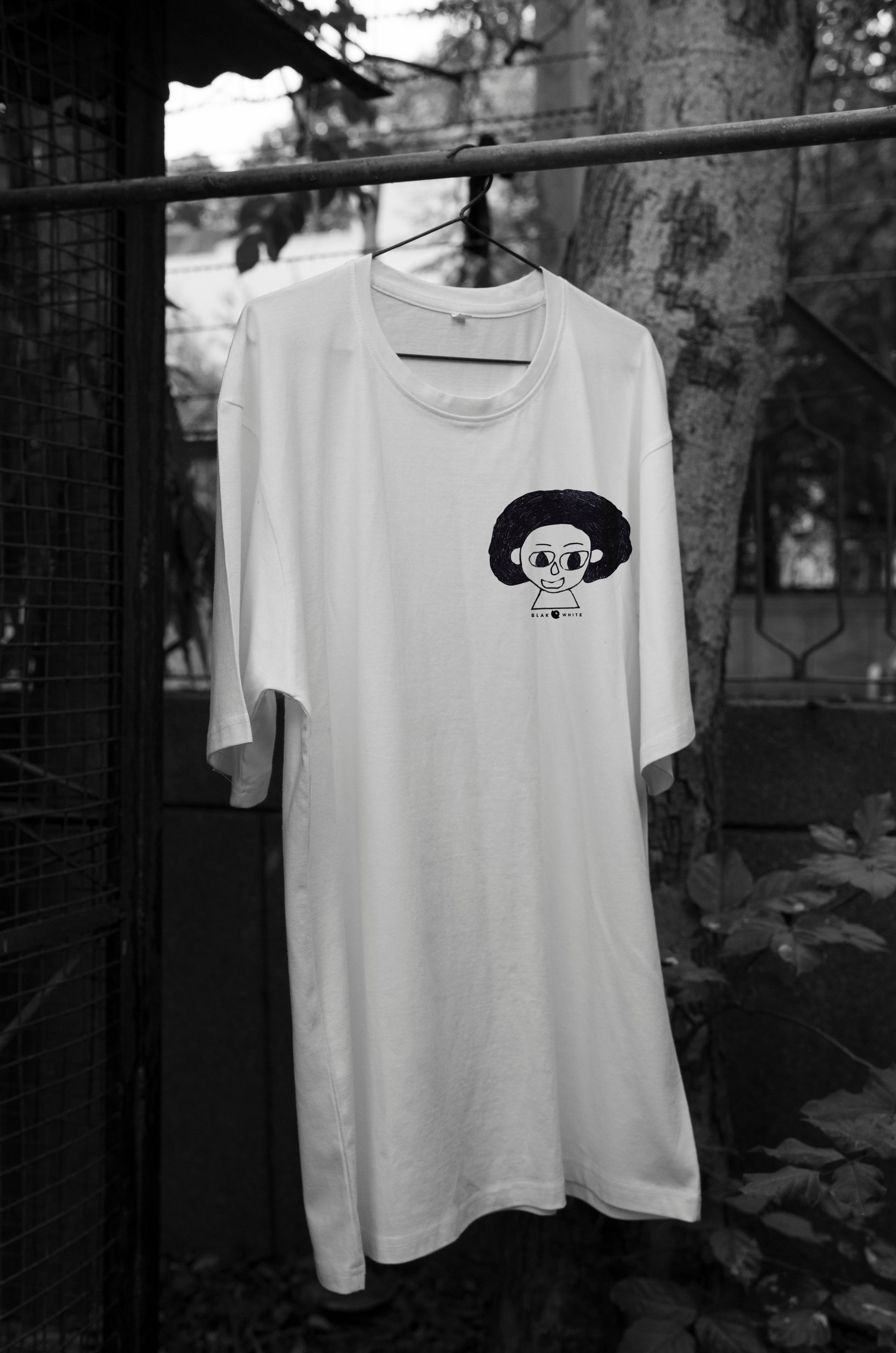 Front view of The Artist white oversized unisex t-shirt by Blaknwhite — minimal streetwear design.