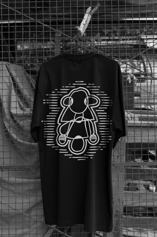 Oversized black T-shirt with a round neck and short sleeves, featuring a white graphic design of a figure and text on the front.