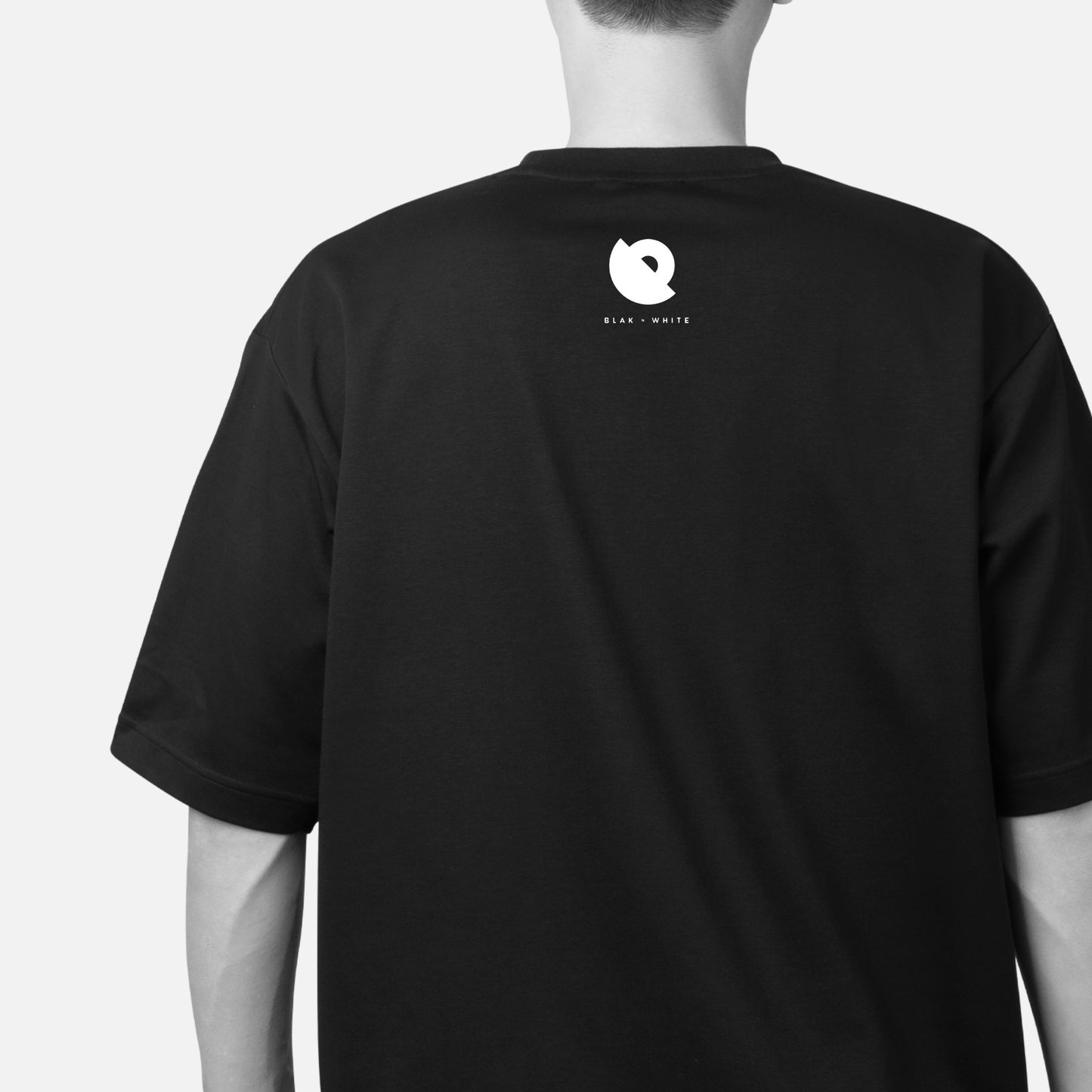 Back design of The Ogler unisex oversized t-shirt — Blaknwhite